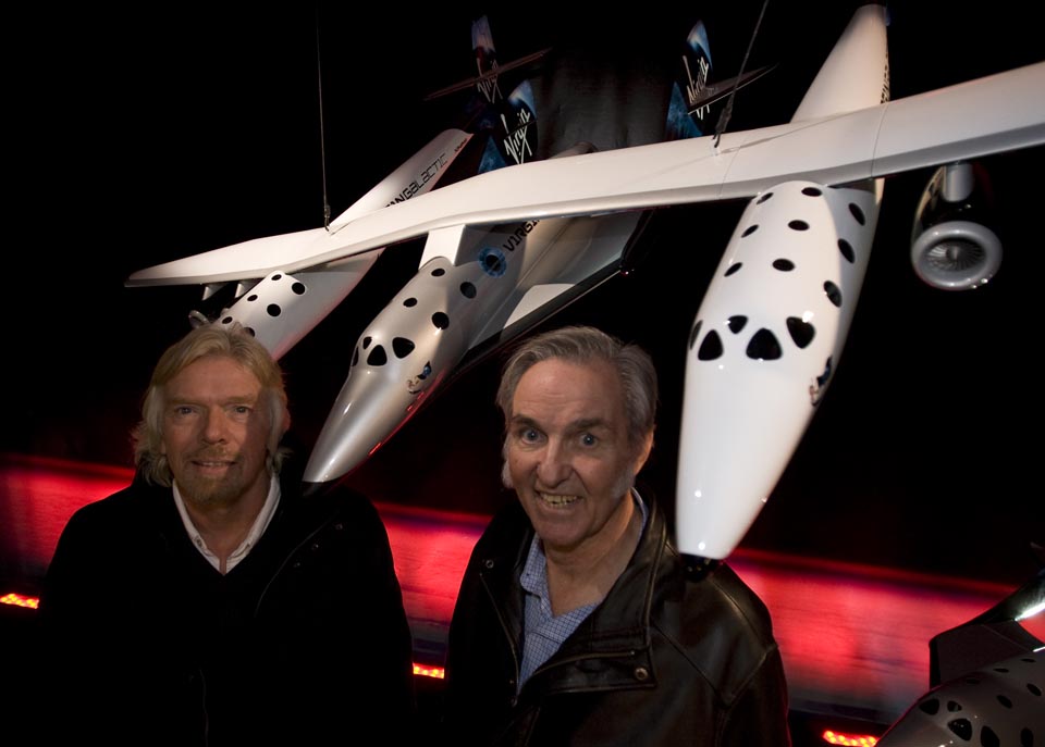 Richard Branson and Burt Rutan in front of a model of the combined WhiteKnightTwo and SpaceShipTwo